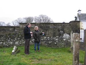 The author, Dorothy Arthur, studying headstone inscriptions at Derrykeighan Old Church Graveyard with Dr William Roulston of the Ulster Historical Foundation